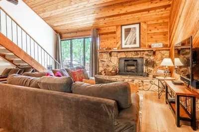 a living room with a couch and a fireplace at Snowflower #79 - Updated 2 Bedroom & Loft, 3 Bath, Sleeps 8, Steps away from Free Town Shuttle in Mammoth Lakes