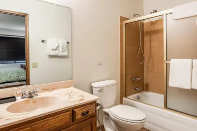 a bathroom with a sink and a toilet and a shower at Snowflower #79 - Updated 2 Bedroom & Loft, 3 Bath, Sleeps 8, Steps away from Free Town Shuttle in Mammoth Lakes