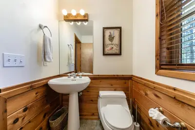 a bathroom with a white toilet and a sink at Horizon at Tahoe Donner w Private Hot Tub and Mountain Views in Truckee