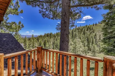 a wooden deck with a view of a tree at Horizon at Tahoe Donner w Private Hot Tub and Mountain Views in Truckee