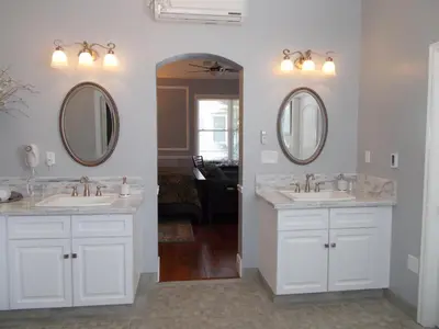 a bathroom with two sinks and two mirrors at The Inn at 161 in Sutter Creek