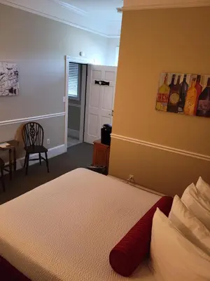 a bedroom with a bed and a room with a window at The Inn at 161 in Sutter Creek