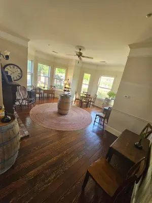 a living room with a large room with tables and chairs at The Inn at 161 in Sutter Creek