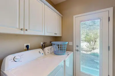 a kitchen with a white sink and a window at Creekside & Cozy in Bass Lake