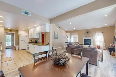 a kitchen and living room with a table and a couch at Creekside & Cozy in Bass Lake