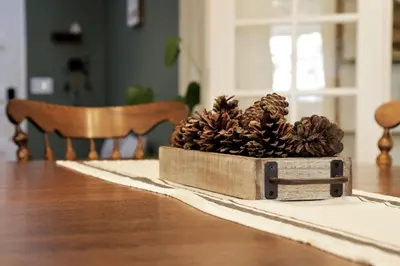 a box filled with pine cones on a table at Home in the Pines - Apple Hill - Dog Friendly - Snow Nearby in Pollock Pines