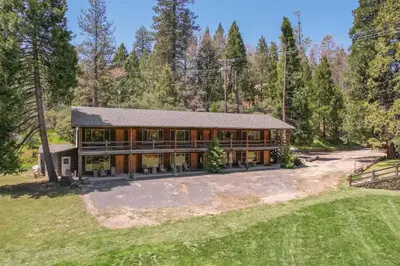 an aerial view of a large house with trees at Camp Nelson Lodge Room 2 in Ponderosa