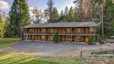 a home in the woods with a large house at Suite Meadow @CN Lodge# 7 in Ponderosa