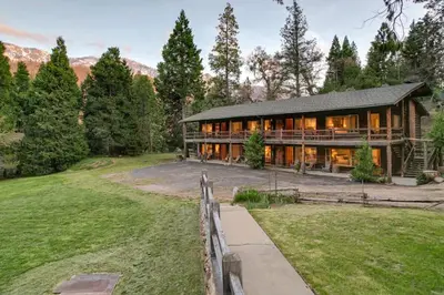 a home in the mountains with a fence at Camp Nelson Lodge Room 6 in Ponderosa