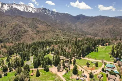 an aerial view of a park with mountains in the background at Mountain Nook CN Lodge #4 in Ponderosa