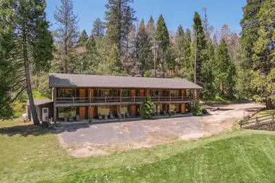 an aerial view of a large house with trees at Bear's Den @CN Lodge #5 in Ponderosa