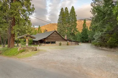 a house with a gravel road in front of it at Bear's Den @CN Lodge #5 in Ponderosa