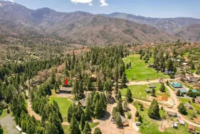 an aerial view of a park with trees and mountains at Bear's Den @CN Lodge #5 in Ponderosa