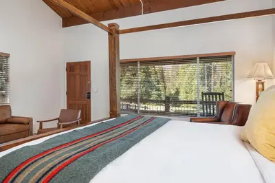 a bedroom with a large bed and a window at Camp Nelson Lodge Room 10 in Ponderosa