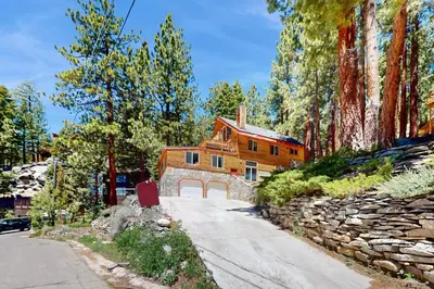 a large wooden house with a stone wall at Summit Sanctuary in Stateline