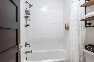 a bathroom with a white tub and a white shower curtain at Creekhouse 1353 in Mammoth Lakes