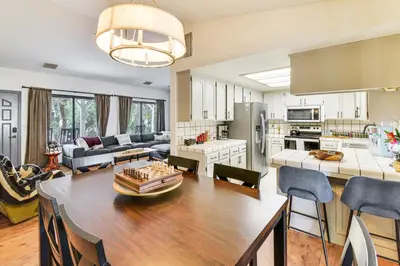 a kitchen and living room with a large wooden table at Yosemite Wellbeing Retreat on 5 Acres with Mtn Views in Ahwahnee