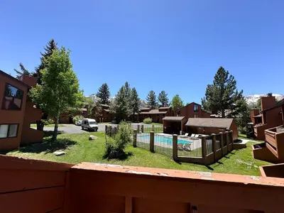 a backyard with a fence and a yard with a pool at Sunrise #33 condo in Mammoth Lakes