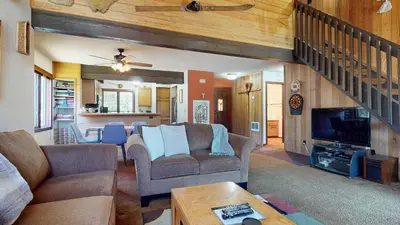 a living room with two couches and a tv at Sunrise #33 condo in Mammoth Lakes
