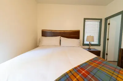 a bedroom with a large white bed and a window at Camp Richardson Resort in South Lake Tahoe