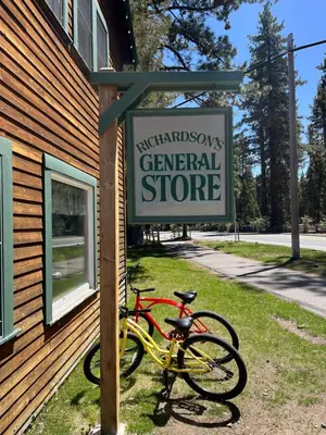 two bikes parked next to a sign for a general store at Camp Richardson Resort in South Lake Tahoe