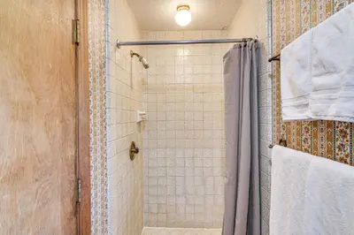 a bathroom with a shower with a shower curtain at Game Room and Hot Tub Serene Grand Mountain Chalet! in Stateline