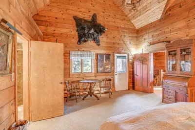 a bedroom with a table and chairs in a cabin at Game Room and Hot Tub Serene Grand Mountain Chalet! in Stateline