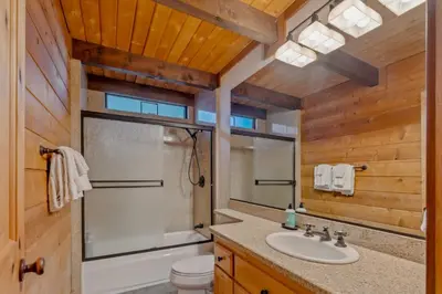 a bathroom with a sink and a toilet and a mirror at 3BR with Sauna & Lake Views, 2 miles to Beach in Tahoe City