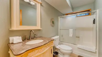 a bathroom with a sink and a toilet and a shower at Paige Meadow by AvantStay Near Lake Tahoe City in Tahoe City