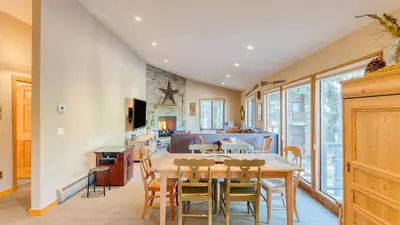 a kitchen and dining room with a table and chairs at Paige Meadow by AvantStay Near Lake Tahoe City in Tahoe City
