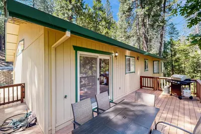 a house with a table and chairs on a deck at Fire Pit, Near Lake Evergreen Escape in Arnold in Arnold