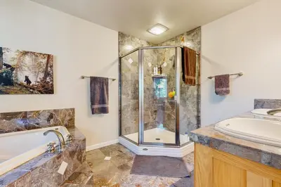 a bathroom with a shower and a tub and a sink at Fire Pit, Near Lake Evergreen Escape in Arnold in Arnold