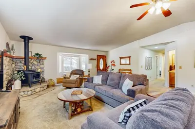 a living room with a couch and a fireplace at Fire Pit, Near Lake Evergreen Escape in Arnold in Arnold