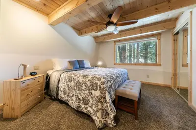 a bedroom with a bed and a ceiling fan at 10th Mountain Home - 4BR Tahoe Donner w Hot Tub, HOA amenities! in Truckee
