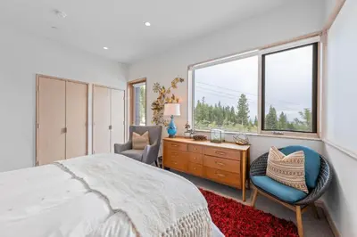 a bedroom with a bed and a desk and a window at Elevation Ski-in, Ski-out in Northstar w Private Hot Tub & HOA Amenities in Truckee