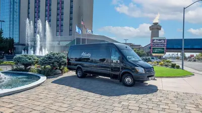 a black van parked in front of a fountain at Atlantis Casino Resort Spa in Reno