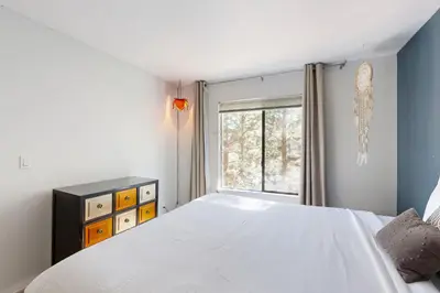 a bedroom with a white bed and a window at Pine in the Sky in Truckee