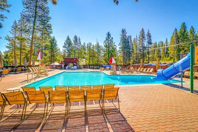 a swimming pool with chairs and a slide at Pine in the Sky in Truckee