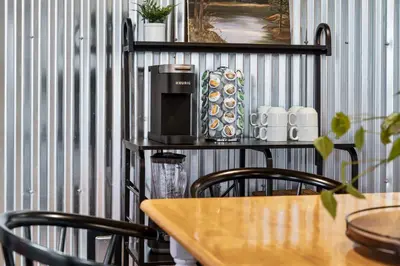 a table with a coffee maker on a shelf at The Pine Loft | Yosemite in North Fork