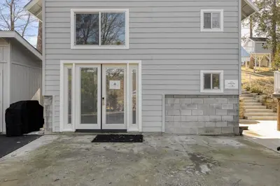 a house with a white door and a driveway at The Pine Loft | Yosemite in North Fork