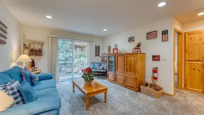 a living room with a blue couch and a table at Tahoe Vista by AvantStay Central Location Patio in Tahoe Vista