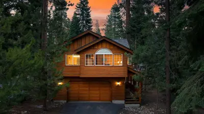 a house with a garage in the woods at Tahoe Vista by AvantStay Central Location Patio in Tahoe Vista