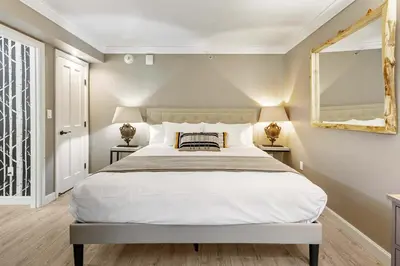 a bedroom with a large bed and a mirror at Everline Resort and Spa 1BR Suite with Fireplace in Olympic Valley