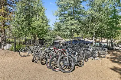 a row of bikes parked next to a fence at Everline Resort and Spa 1BR Suite with Fireplace in Olympic Valley