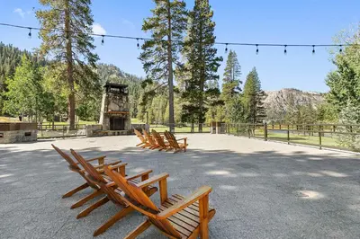 a group of wooden benches in a park at Everline Resort and Spa 1BR Suite with Fireplace in Olympic Valley