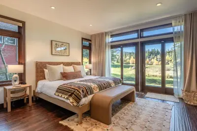 a bedroom with a bed and large windows at Snowcreek V 731 in Mammoth Lakes