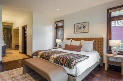 a bedroom with a large bed and a bathroom at Snowcreek V 731 in Mammoth Lakes