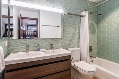 a bathroom with a sink and a toilet and a mirror at Snowcreek V 731 in Mammoth Lakes