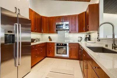 a kitchen with wooden cabinets and a stainless steel refrigerator at Snowcreek V 731 in Mammoth Lakes