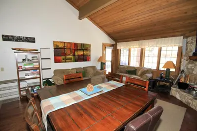 a living room with a wooden table and a couch at Mountainback 68 2 bedroom with loft in Mammoth Lakes